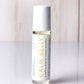 Roll-on bottle labeled 'Calm Belly Dreams' for stomach discomfort and nausea