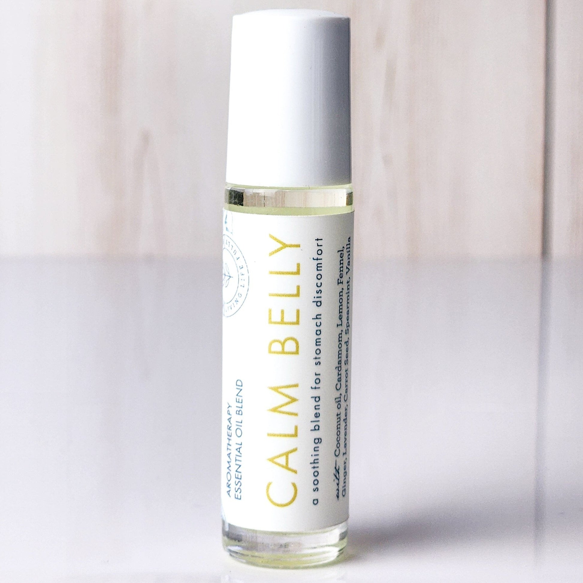 Roll-on bottle labeled 'Calm Belly Dreams' for stomach discomfort and nausea