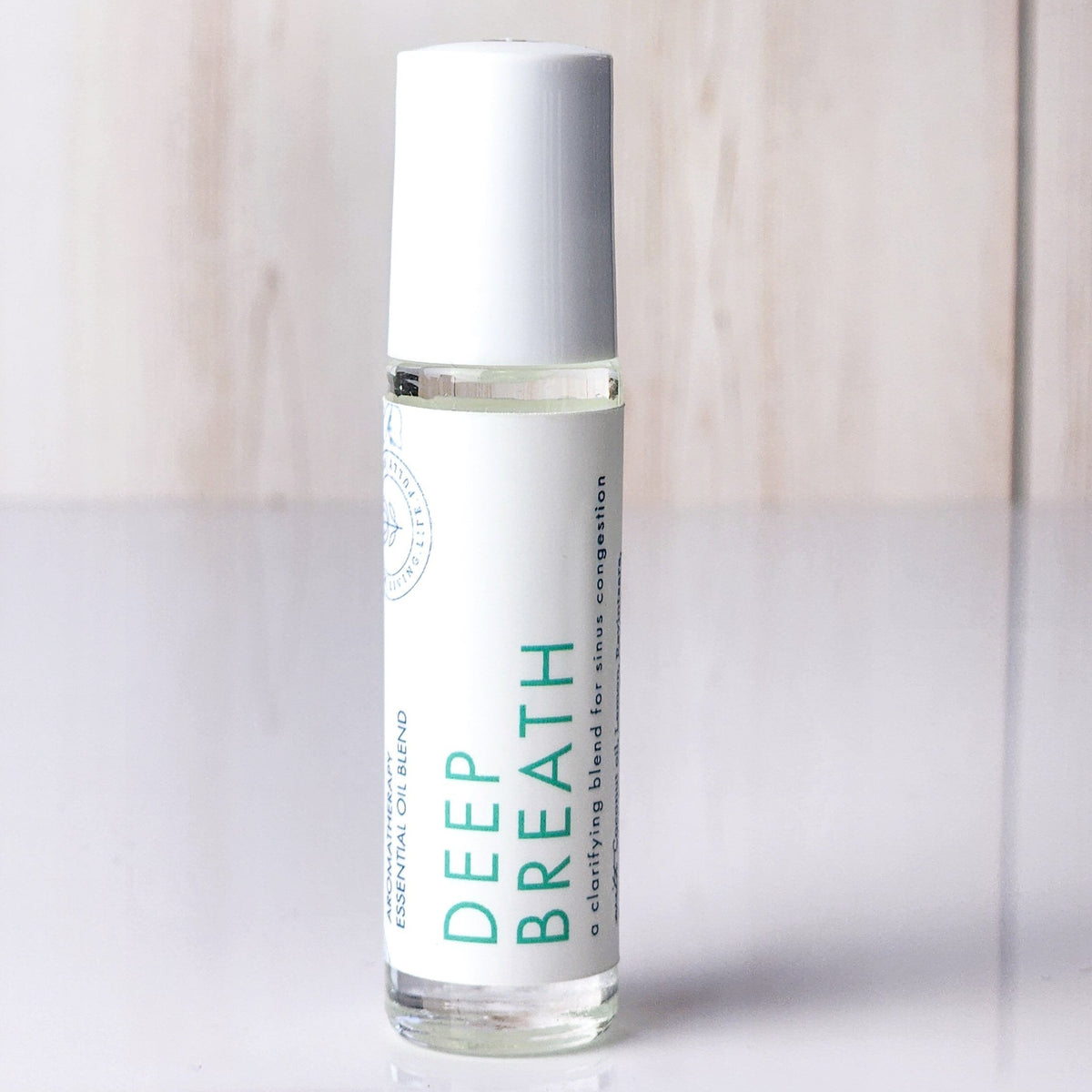 Hello Wellness Deep Breath aromatherapy essential oil roll-on in a clear glass bottle with a white cap, a clarifying sinus blend.