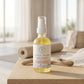 Bottle of repairing body oil on a wooden table with a blurred indoor background
