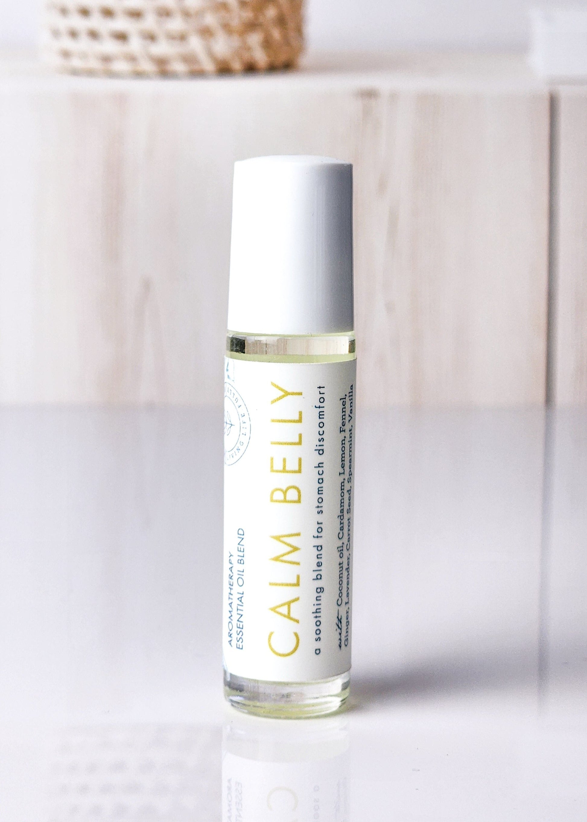 Roll-on bottle labeled 'Calm Belly Dreams' for stomach discomfort and nausea 