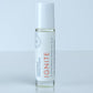 Roll-on bottle labeled 'IGNITE' for mood boost on a light gray background