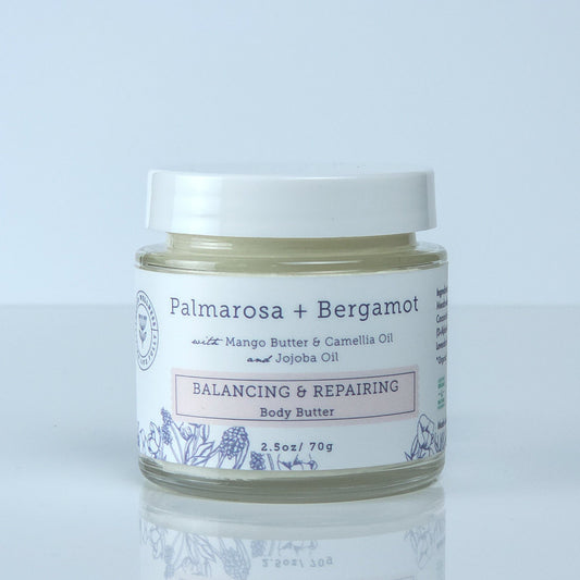 Jar of Palmarosa + Bergamot body butter on a light gray background