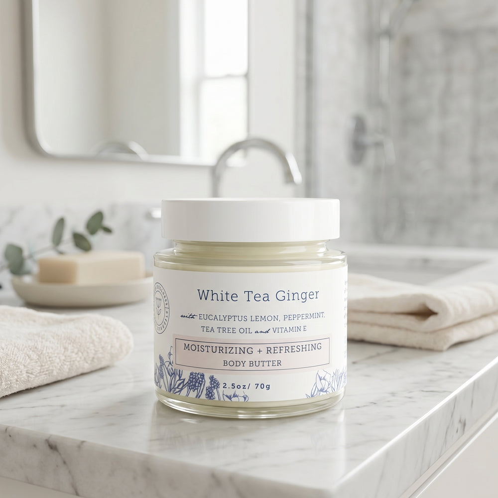 Jar of White Tea Ginger body butter on a bathroom counter. Eczema relief. Hello wellness