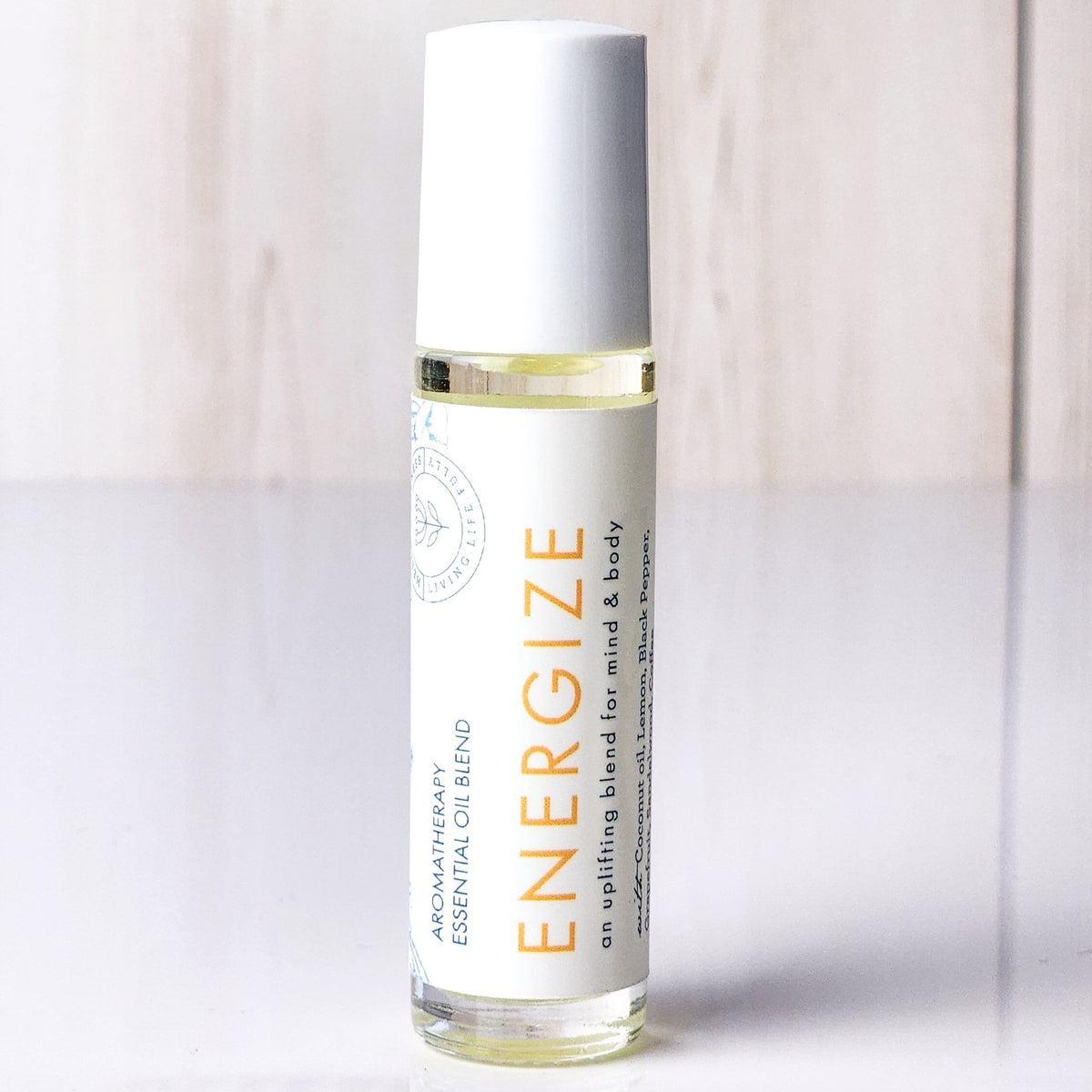 Hello Wellness Energize aromatherapy essential oil roll-on in a clear glass bottle with a white cap, an uplifting mind and body blend.