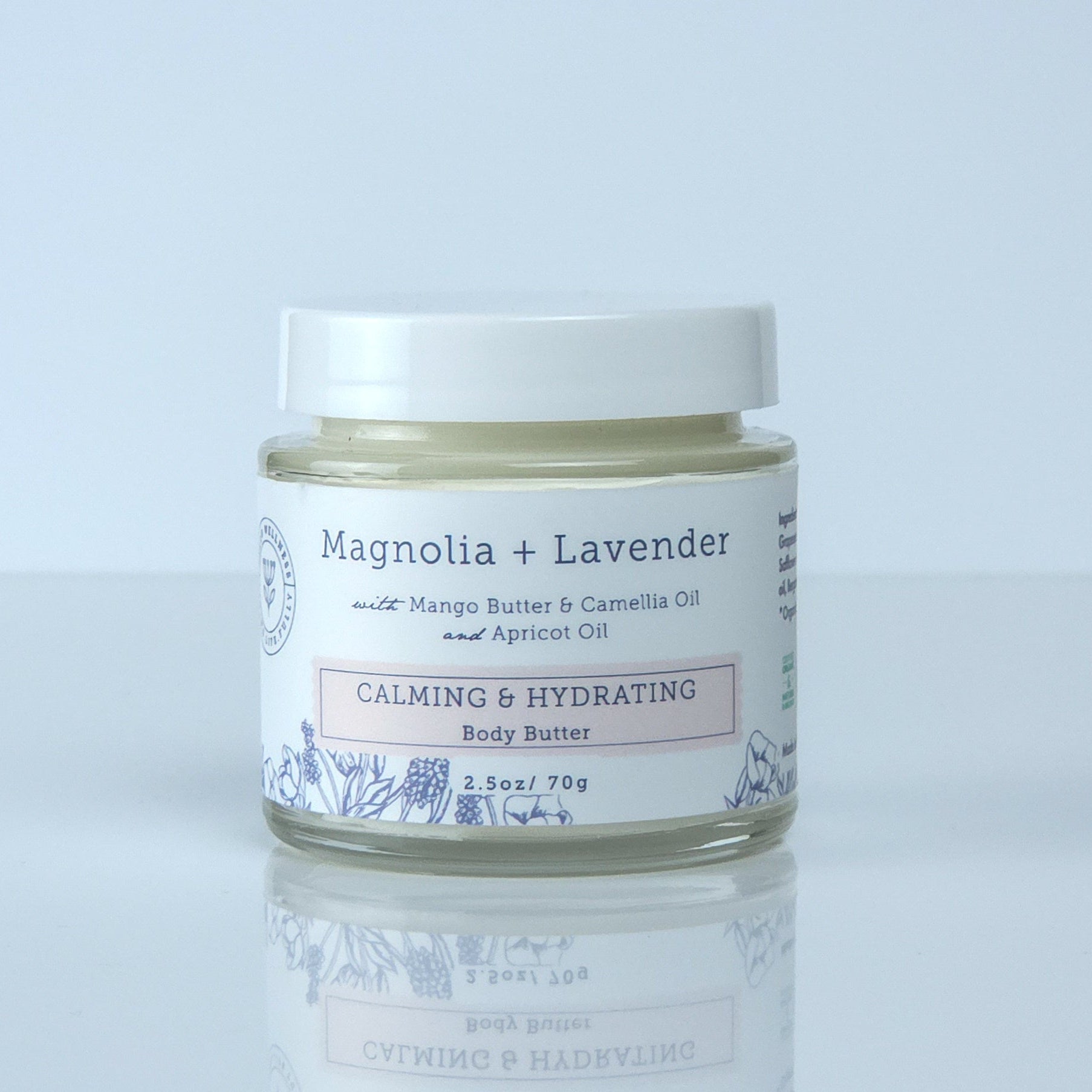 Jar of cream labeled 'Mentha + Lavender' on a light gray background