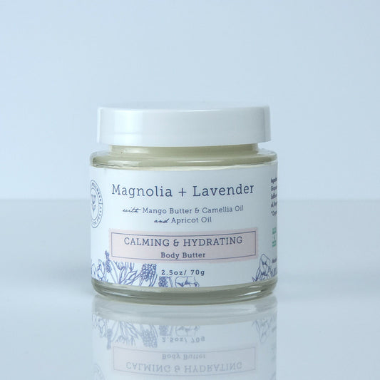 Jar of cream labeled 'Mentha + Lavender' on a light gray background