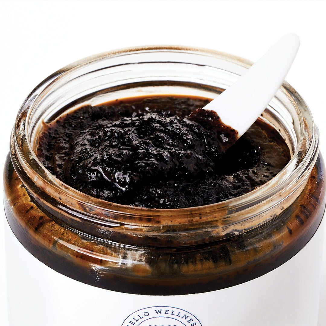 Open jar of Cocoa + Vanilla Invigorating Coffee Body Polish by Hello Wellness. A coffee lover's dream.