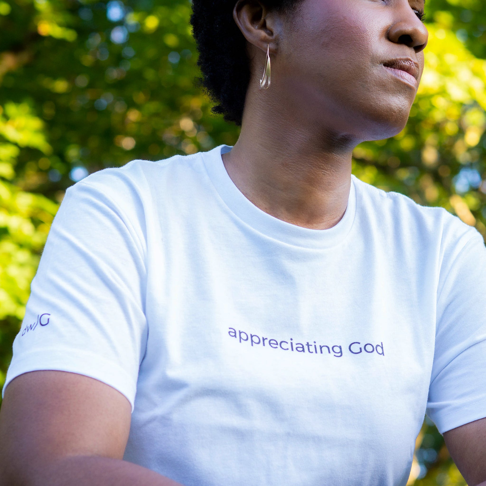 Woman wearing white appreciating God T-Shirt - Design with God