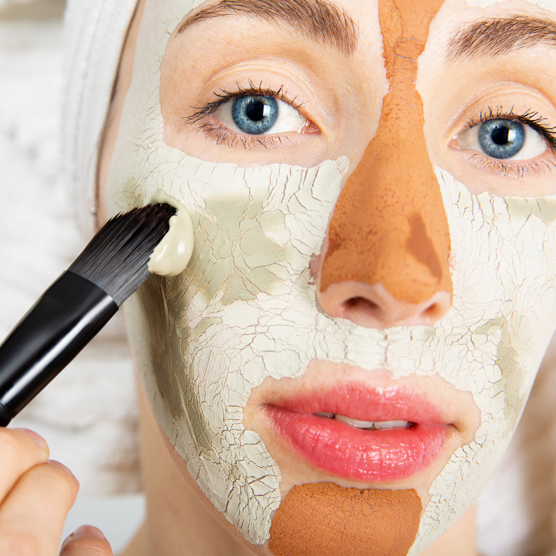 woman applying with applying green and pink clay to face. Perfect for dry and oily combination skin.