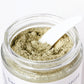 Open jar of green clay mask from Hello Wellness. Excellent for extracting excess sebum from oily skin & tightening.